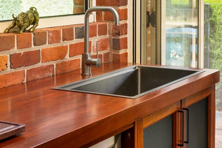 Timber benchtop in a kitchen setting with a sink